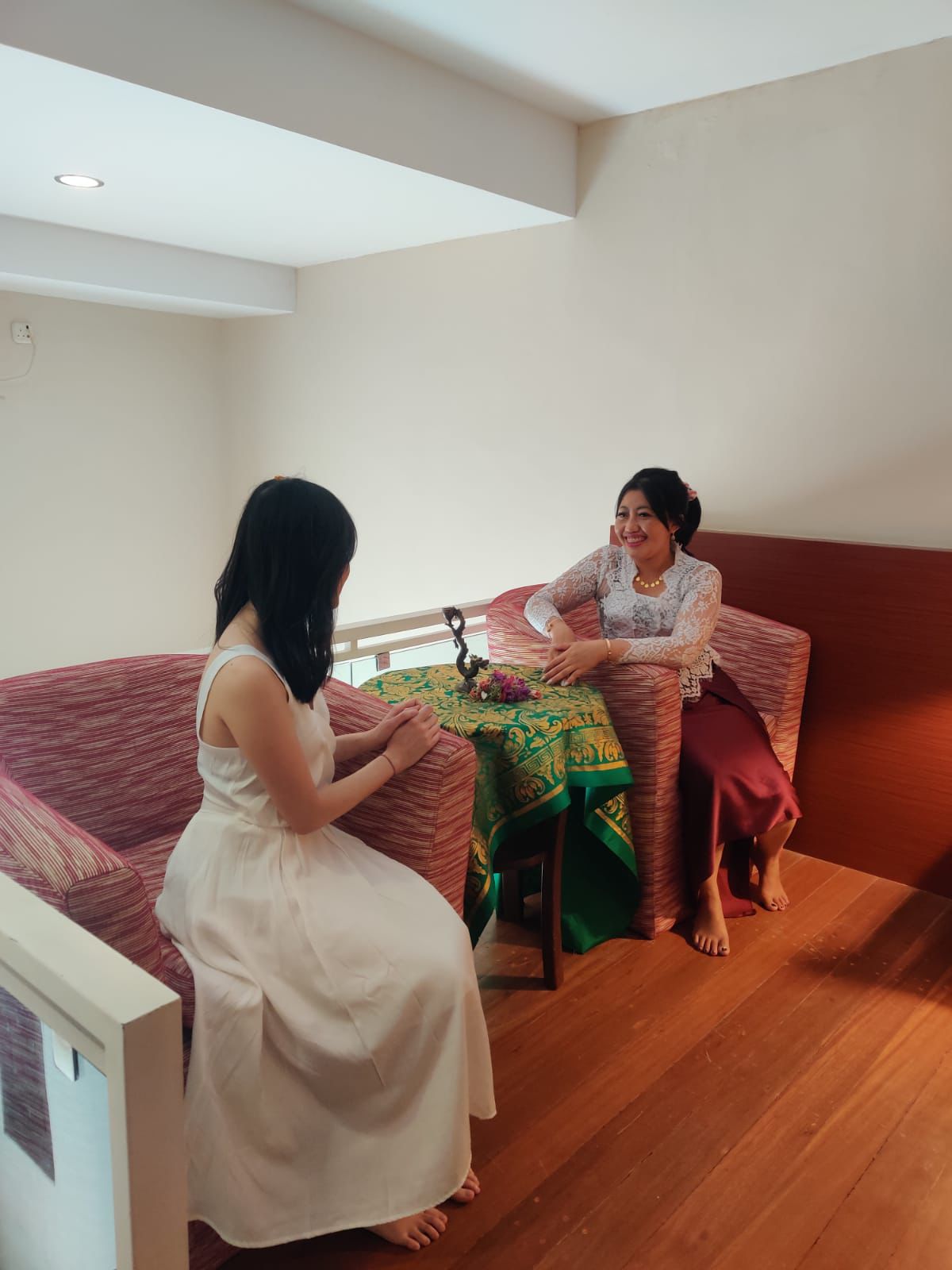Bali Healer Jero Tya doing a healing session with a client.